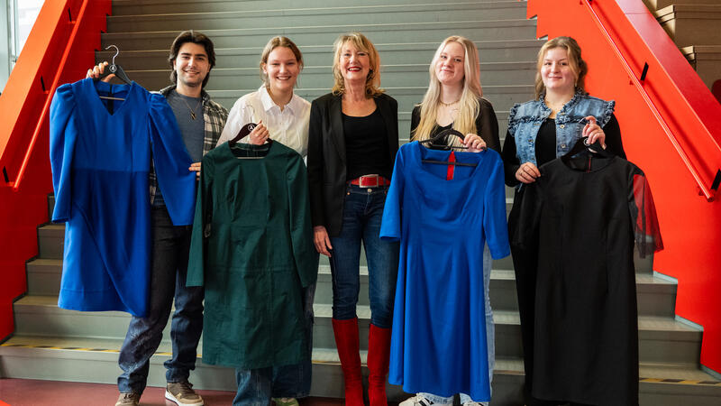 Vier tweedejaarsstudenten van de opleiding Fashion tailor poseren met hun kledingstuk met Ellen Marks